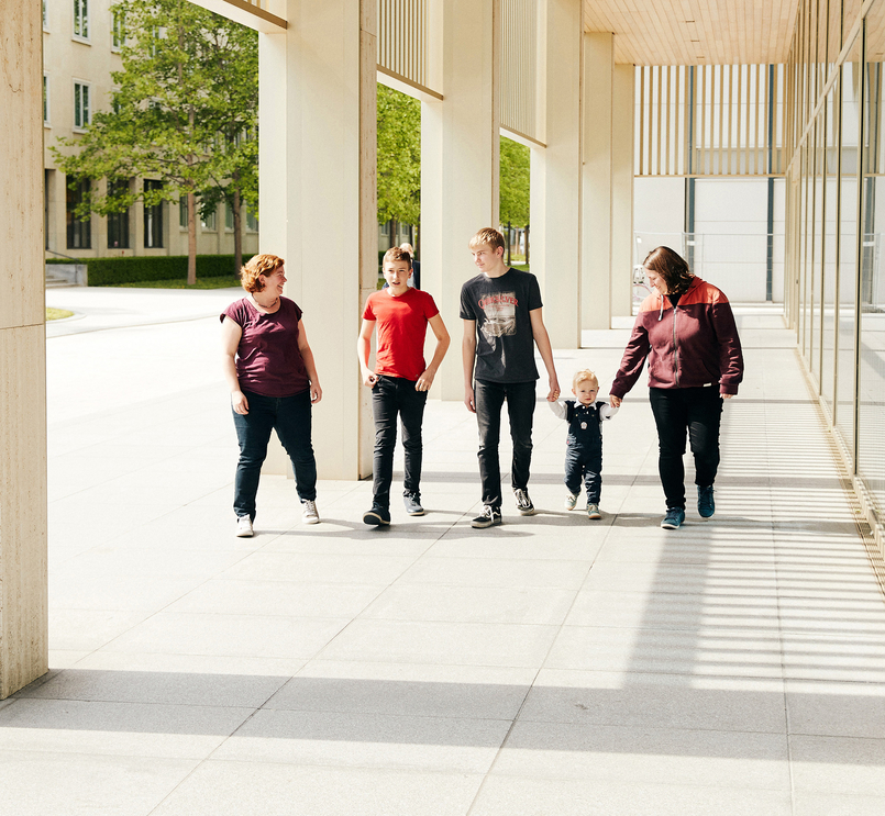 Happy family walking on Basel campus