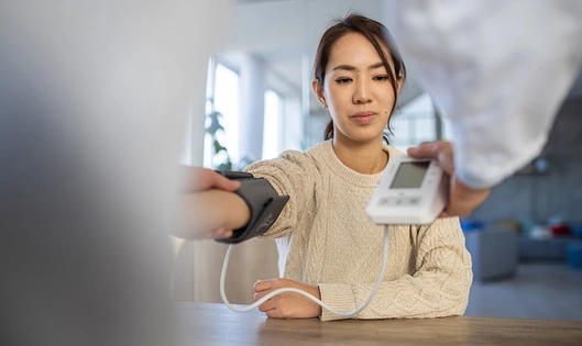 A patient having her blood pressure measured with a machine