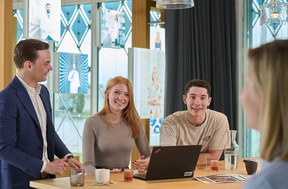 Early careers professionals smile at camera