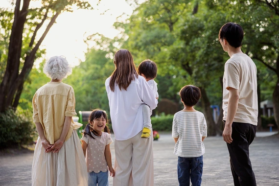 A family standing outside looking into the sunset