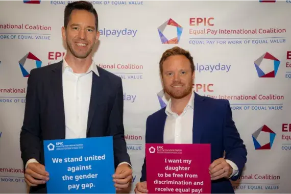 Two men holding signs