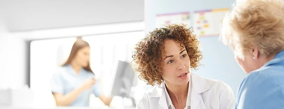 A doctor speaks with a patient