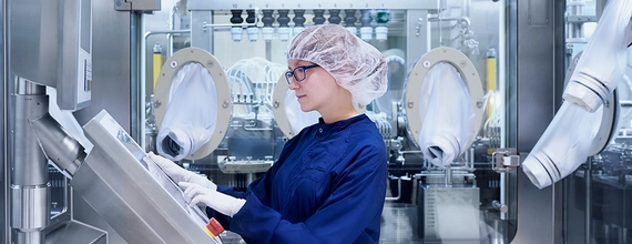 A scientist in operating a machine in a laboratory