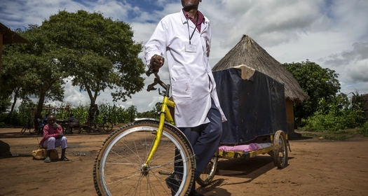 Tricycle with a house-shaped cart in a rural setting