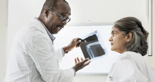 Two doctors examining X-ray